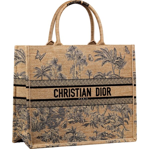 Torba Dior Book Tote z naturalnego płótna z nadrukiem palm i tropikalnej roślinności, ozdobiona czarnym logo Christian Dior Paris.