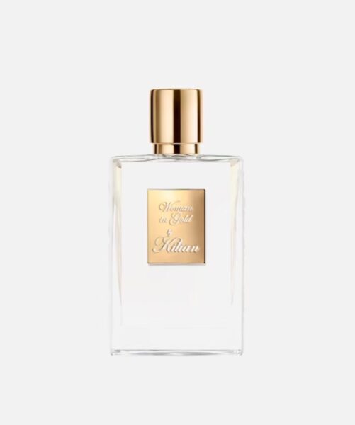 Przezroczysty flakon perfum Woman in Gold by Kilian z eleganckim złotym korkiem i tabliczką.